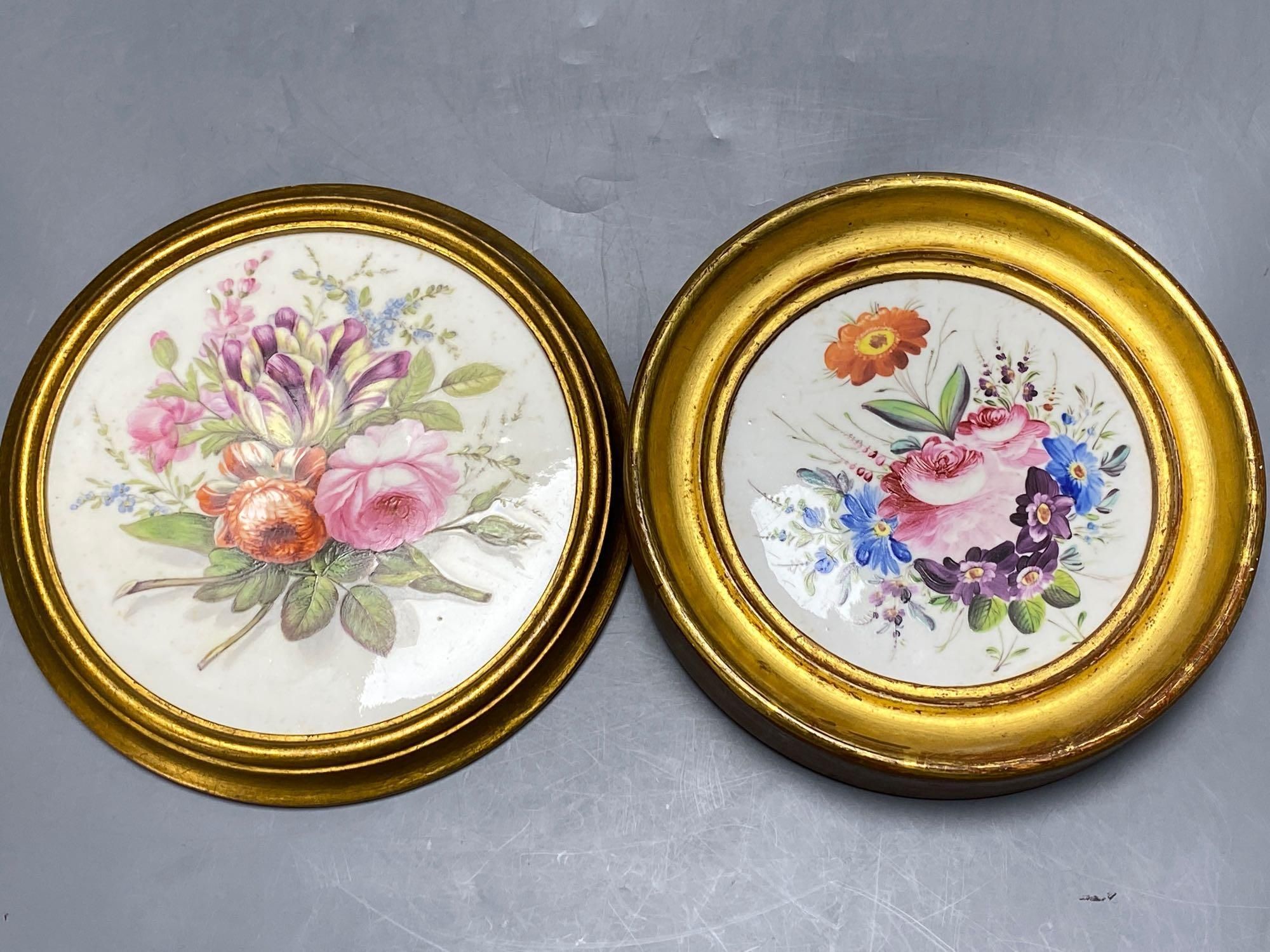 Two early 19th century circular wall plaques, each painted with floral bouquets, one Derby, 18cm and 16cm